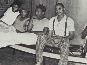 Five male students sit together in a 1974 black and white photo